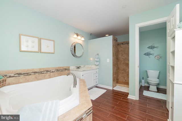 bathroom featuring vanity, baseboards, tiled shower, wood finish floors, and a bath