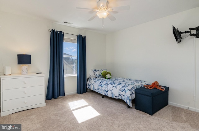 carpeted bedroom with visible vents and ceiling fan