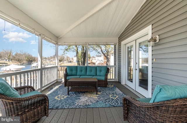 wooden deck featuring outdoor lounge area and a water view