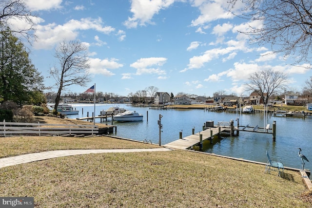 dock area with fence, a yard, cooling unit, and a water view