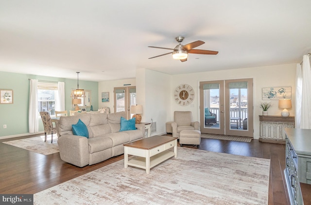 living room with french doors, baseboards, and dark wood-style floors