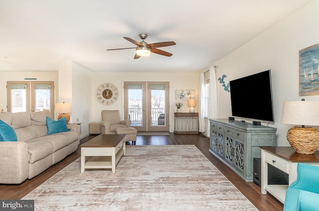 living area featuring dark wood-style floors, french doors, and ceiling fan