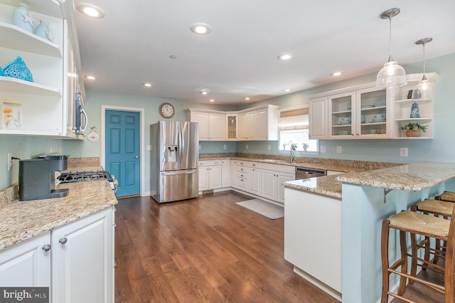 kitchen featuring open shelves, dark wood-style floors, a peninsula, and stainless steel appliances