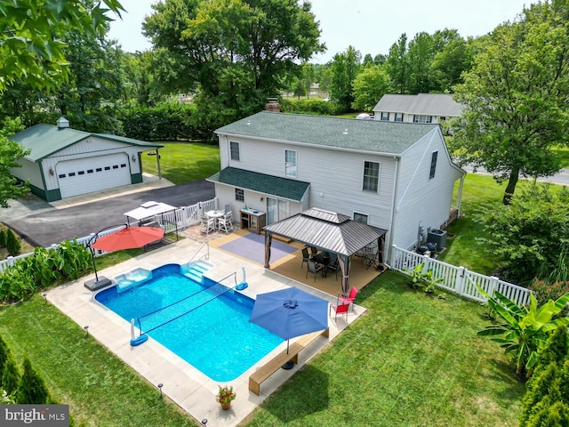 view of swimming pool featuring a fenced in pool, a lawn, a fenced backyard, a gazebo, and an outdoor structure