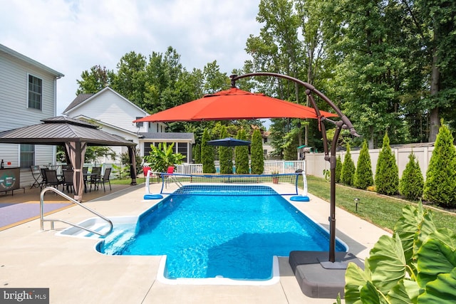 view of pool with a fenced in pool, fence, a gazebo, and a patio