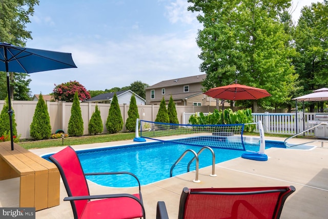 view of pool with a fenced in pool and fence