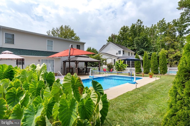 pool featuring a yard, fence, and a gazebo