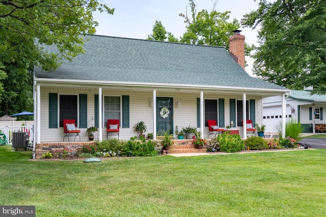 view of front facade with covered porch, a shingled roof, a chimney, and central air condition unit