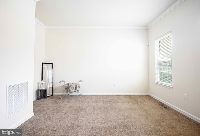 carpeted spare room featuring visible vents, crown molding, and baseboards