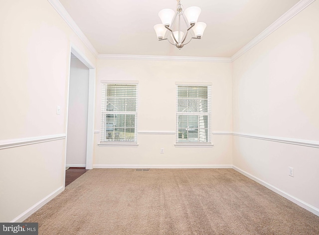 carpeted spare room with a notable chandelier, crown molding, and baseboards