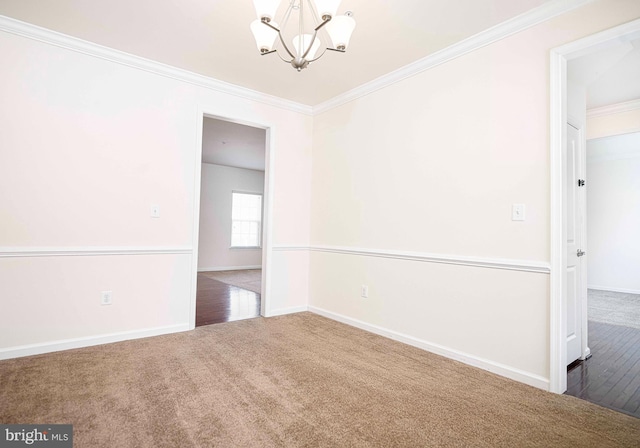 unfurnished room with a chandelier, crown molding, baseboards, and carpet floors