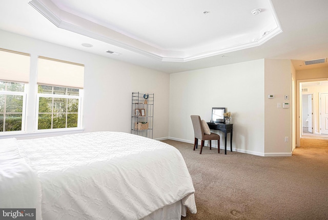 bedroom with visible vents, carpet flooring, baseboards, and a tray ceiling