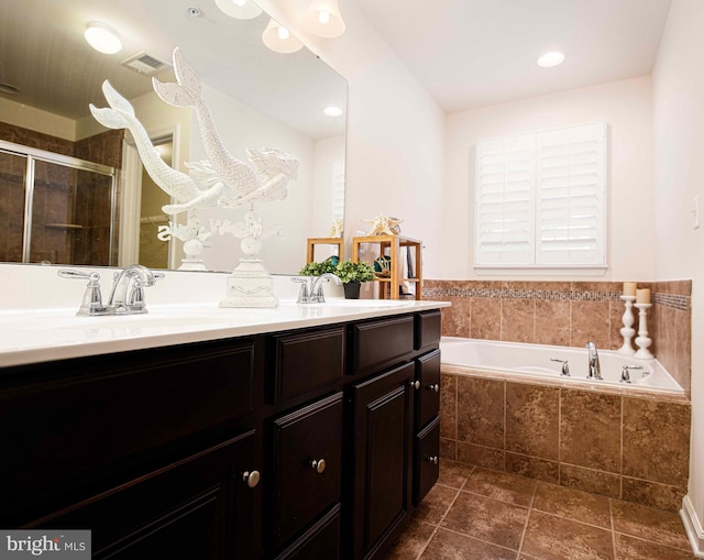 bathroom with a bath, visible vents, a shower stall, and vanity