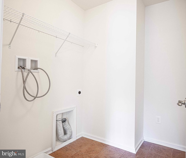 laundry area featuring laundry area, hookup for a washing machine, hookup for an electric dryer, and baseboards