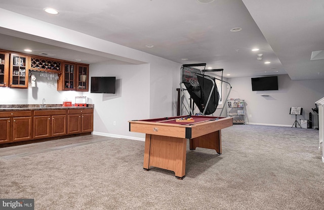 game room with wet bar, light colored carpet, baseboards, and a sink