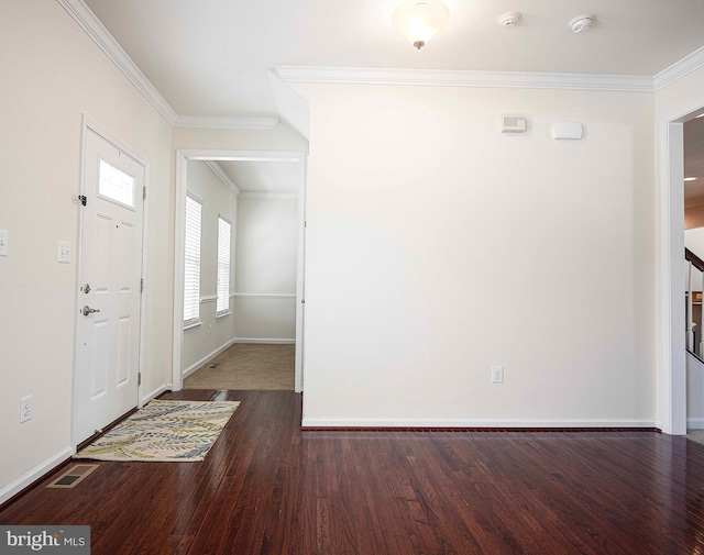 foyer featuring baseboards, wood finished floors, and crown molding