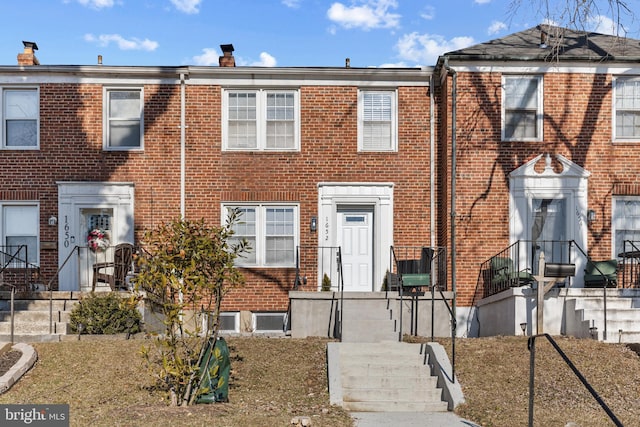 view of property featuring brick siding