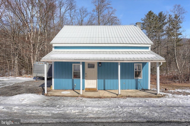 view of front of home with covered porch and metal roof