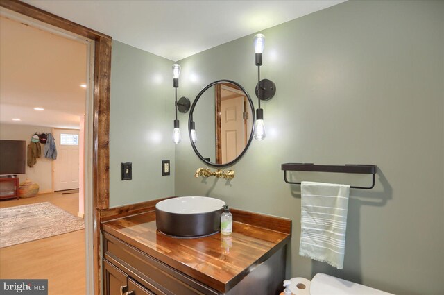 bathroom with vanity and wood finished floors