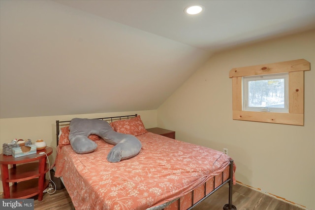 bedroom with lofted ceiling, recessed lighting, and wood finished floors
