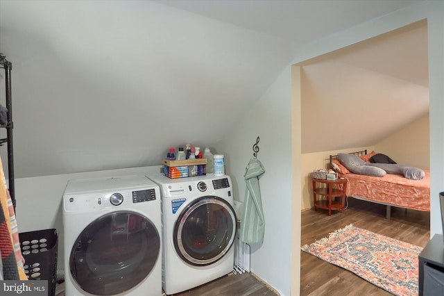 clothes washing area featuring laundry area, separate washer and dryer, and dark wood finished floors