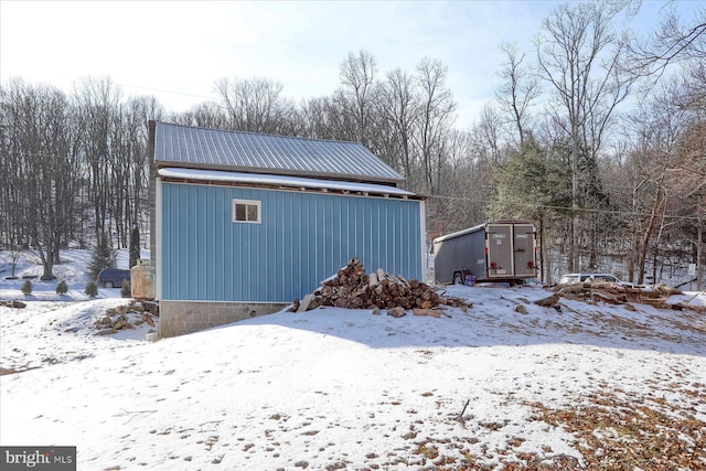 snow covered garage with a garage