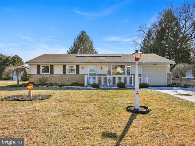 single story home with a porch, a front yard, driveway, and a garage