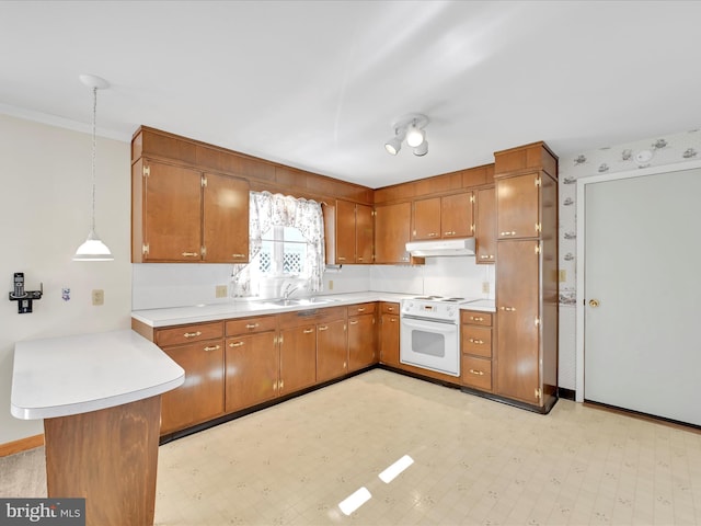 kitchen featuring white range with electric stovetop, brown cabinets, light countertops, under cabinet range hood, and pendant lighting