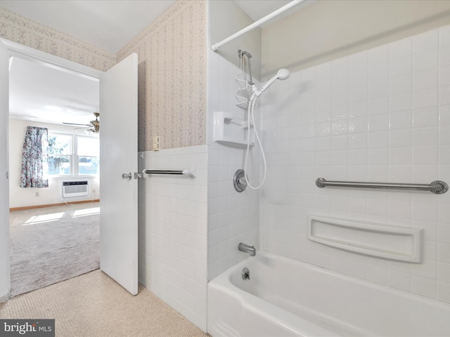 bathroom with wallpapered walls, wainscoting, ceiling fan, an AC wall unit, and shower / bathing tub combination