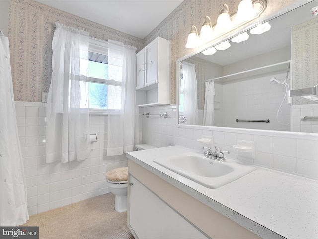 bathroom with toilet, a shower with shower curtain, tile walls, and wallpapered walls