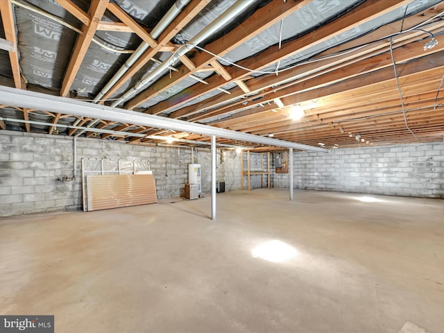 unfinished basement featuring water heater