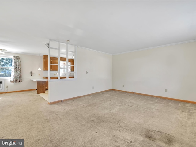 unfurnished living room featuring crown molding, a wealth of natural light, and light colored carpet