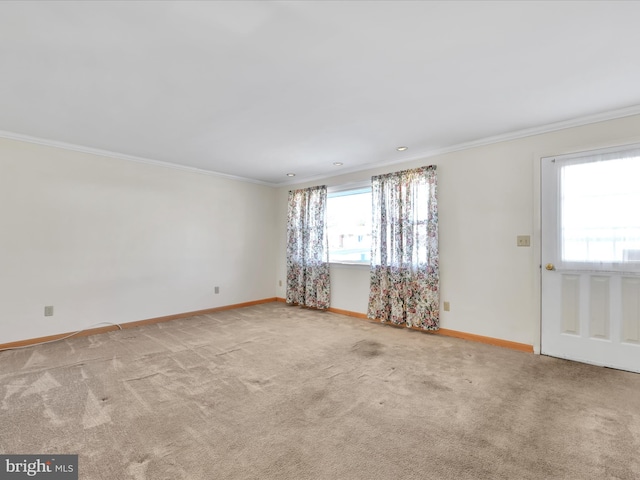 empty room with light carpet, baseboards, and ornamental molding