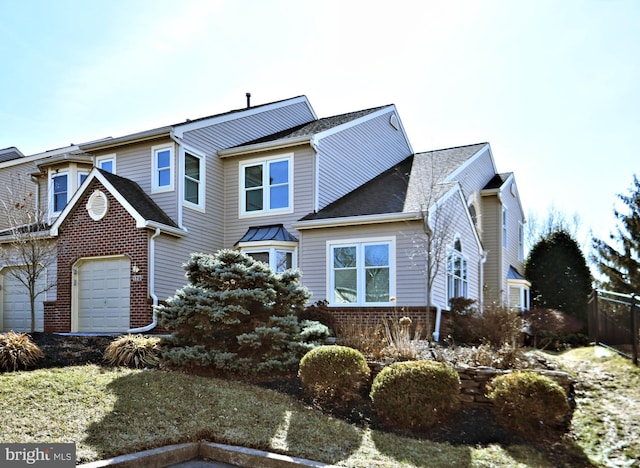 view of front of house featuring a garage and brick siding