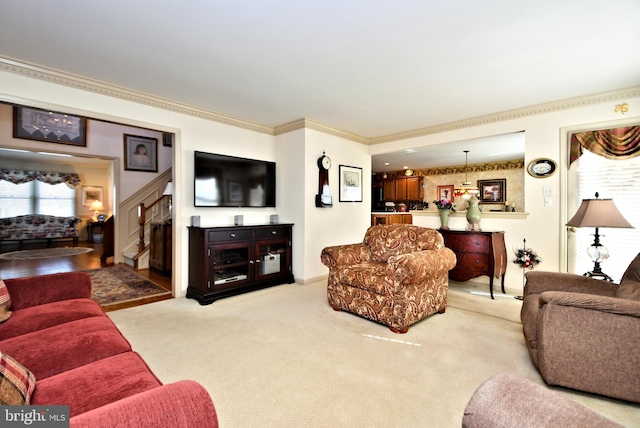 living area featuring stairs, ornamental molding, and light colored carpet