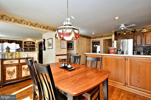 dining room featuring light wood-type flooring, a ceiling fan, and recessed lighting