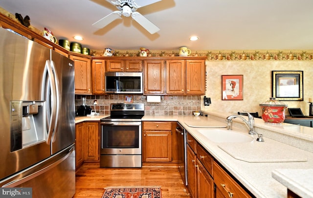 kitchen featuring a sink, stainless steel appliances, and light countertops