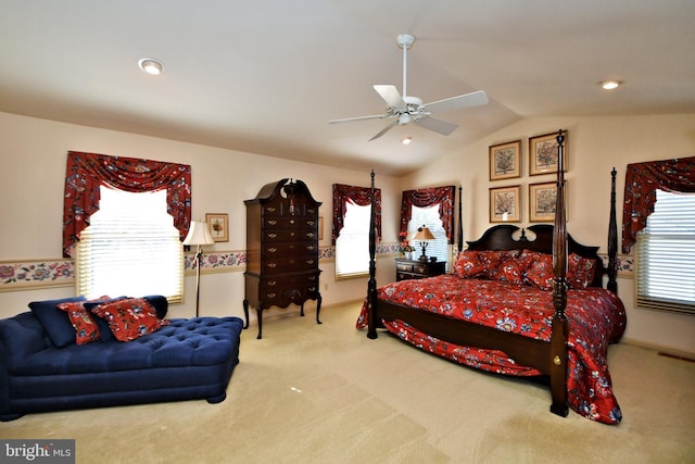 bedroom with carpet floors, ceiling fan, visible vents, and vaulted ceiling