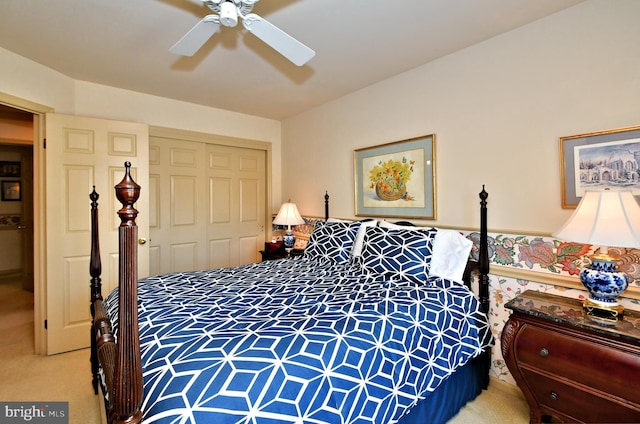 bedroom featuring light carpet, a closet, a ceiling fan, and a wainscoted wall