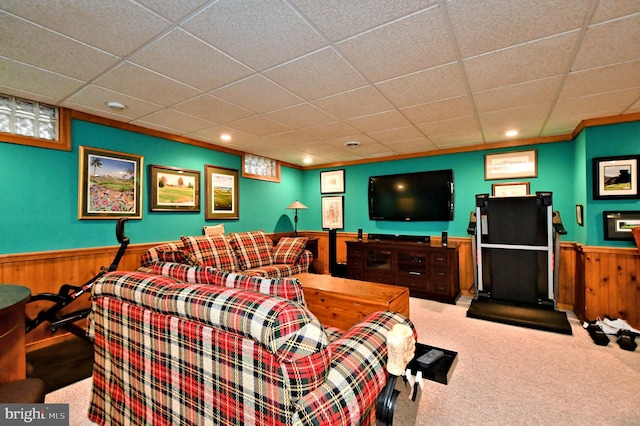 interior space featuring carpet, wainscoting, wood walls, and a paneled ceiling