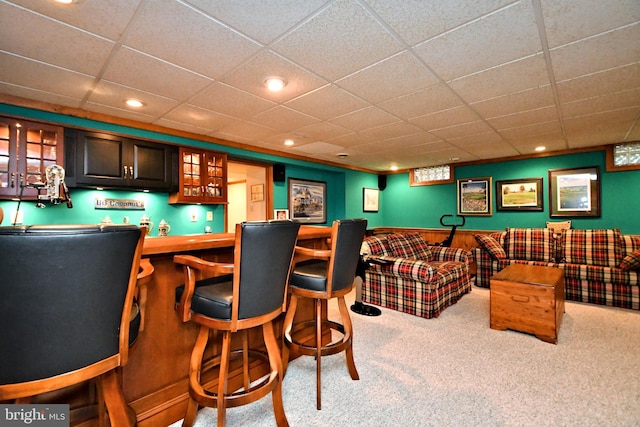 bar featuring light carpet, a bar, a paneled ceiling, and recessed lighting