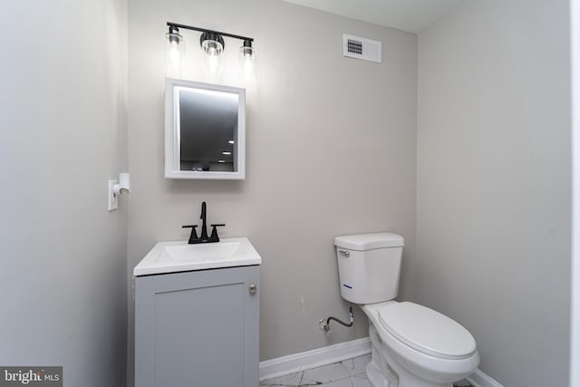 bathroom featuring baseboards, visible vents, toilet, marble finish floor, and vanity