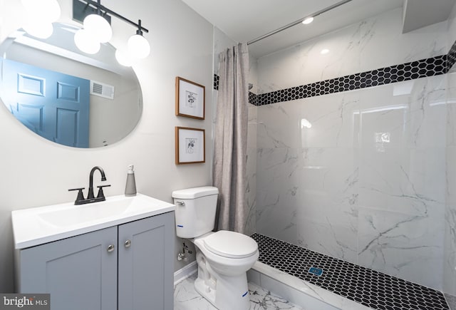 bathroom with toilet, vanity, visible vents, marble finish floor, and a marble finish shower