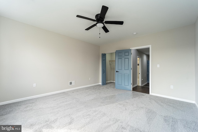 unfurnished bedroom featuring ceiling fan, carpet flooring, visible vents, and baseboards