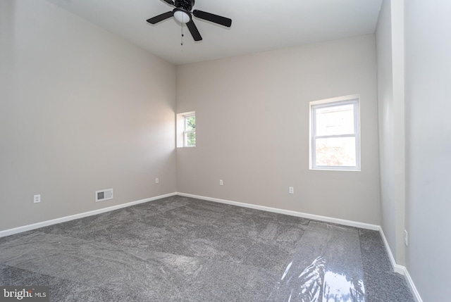 unfurnished room with carpet, visible vents, ceiling fan, and baseboards