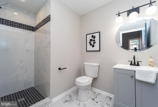 bathroom with toilet, vanity, baseboards, marble finish floor, and a marble finish shower