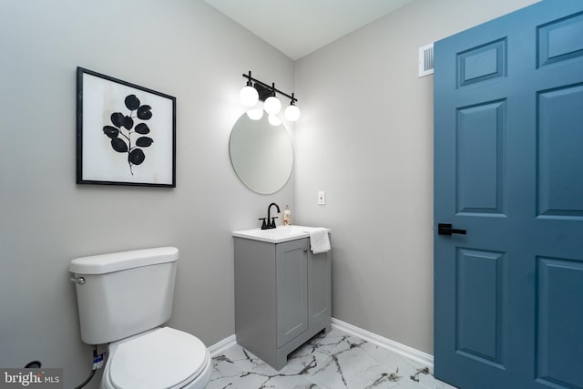 bathroom with toilet, visible vents, vanity, baseboards, and marble finish floor