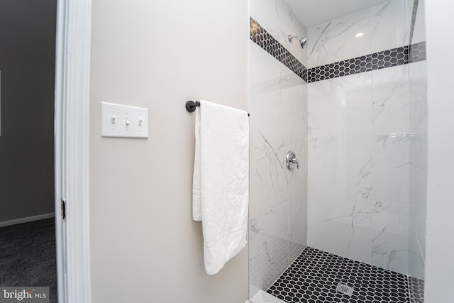 bathroom with a marble finish shower