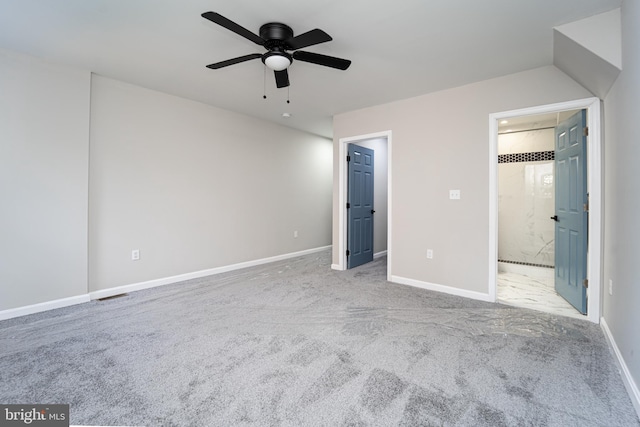 unfurnished bedroom with visible vents, light colored carpet, a spacious closet, connected bathroom, and baseboards