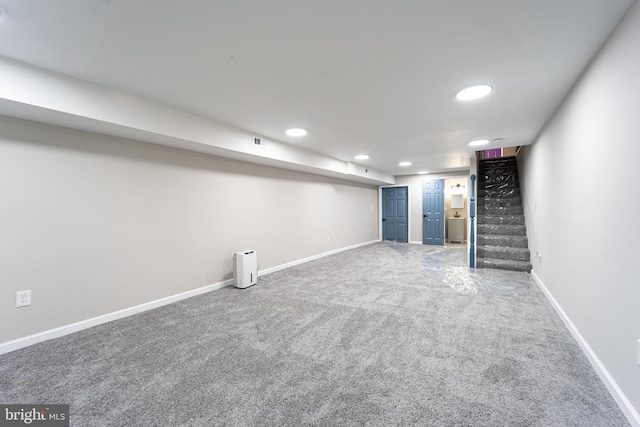 finished below grade area featuring carpet floors, recessed lighting, baseboards, and stairs